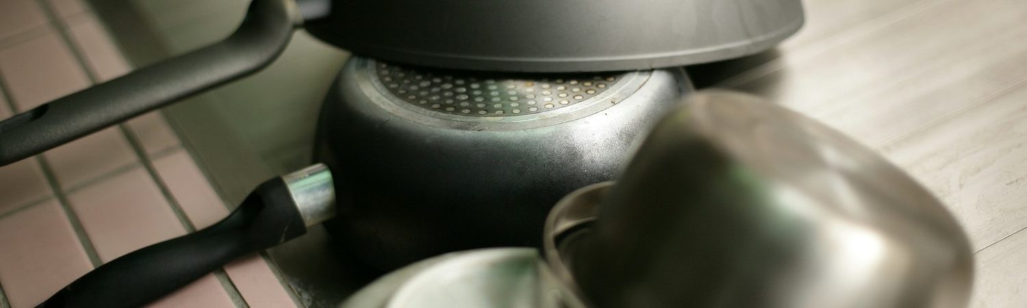 Two frying pans stacked on a stovetop