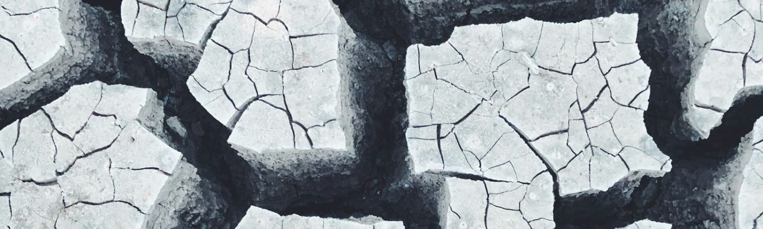 Cracked dry ground with separated pieces of earth