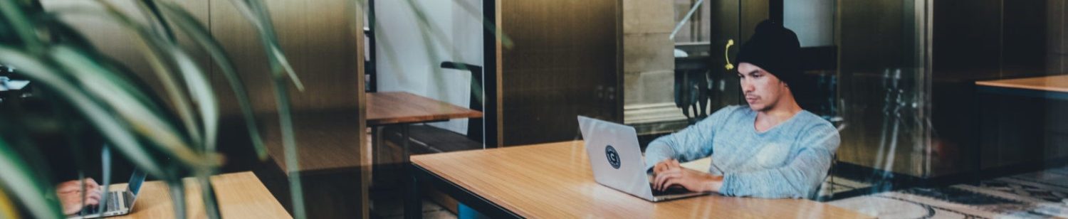 A person working at a laptop in a quiet room