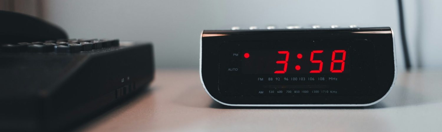 A digital clock on a desk