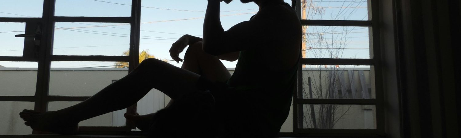 A person sitting by a window in morning light